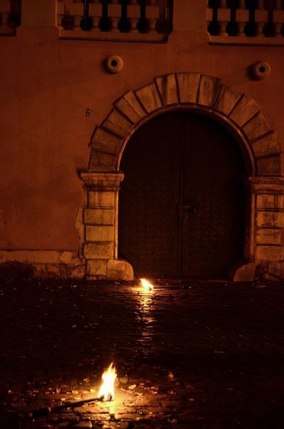 A fire on the cobblestones at night